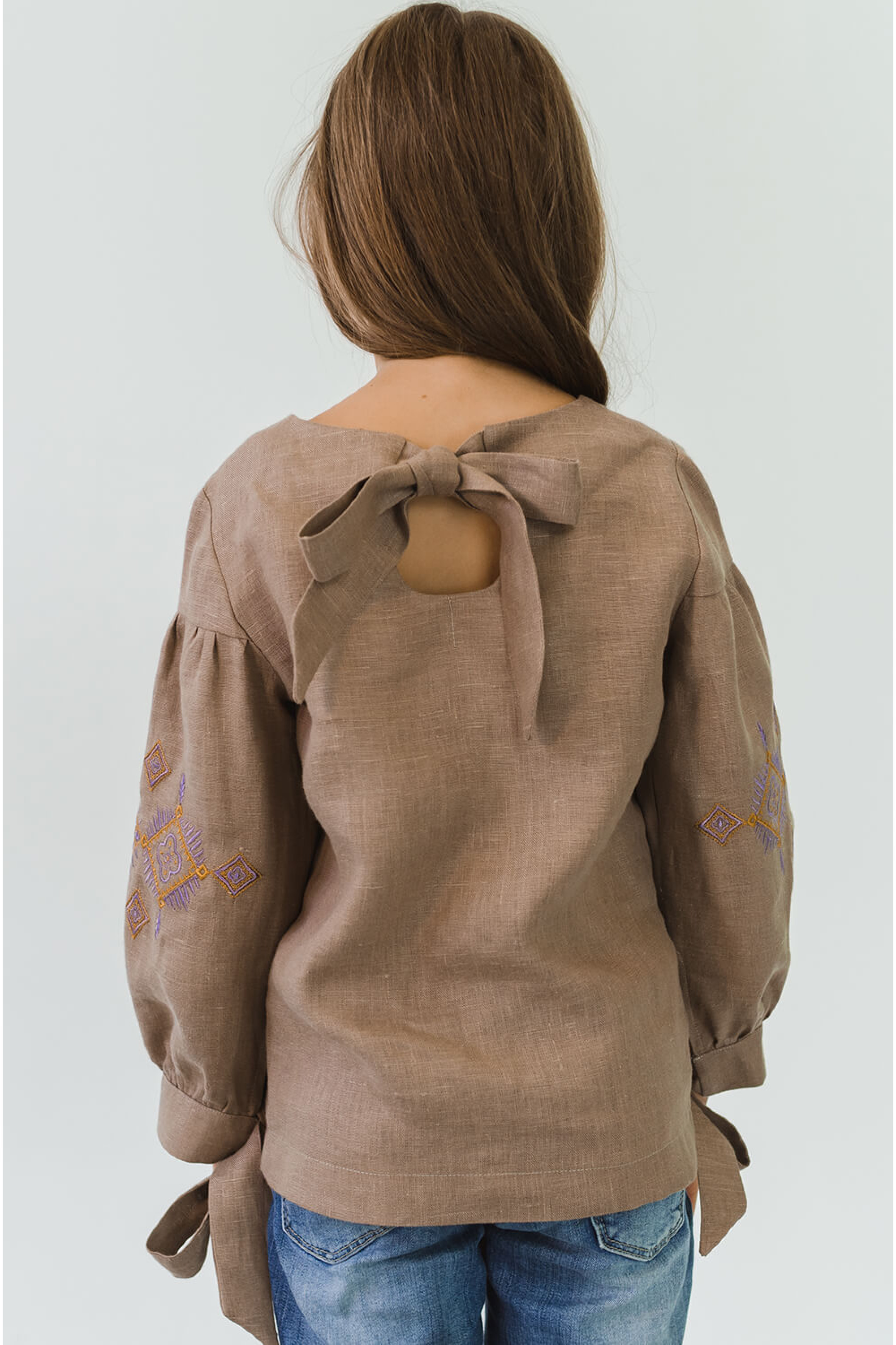 Embroidered blouse for a girl with bsuffe bows Embroidered blouse for a girl with bsuffe bows