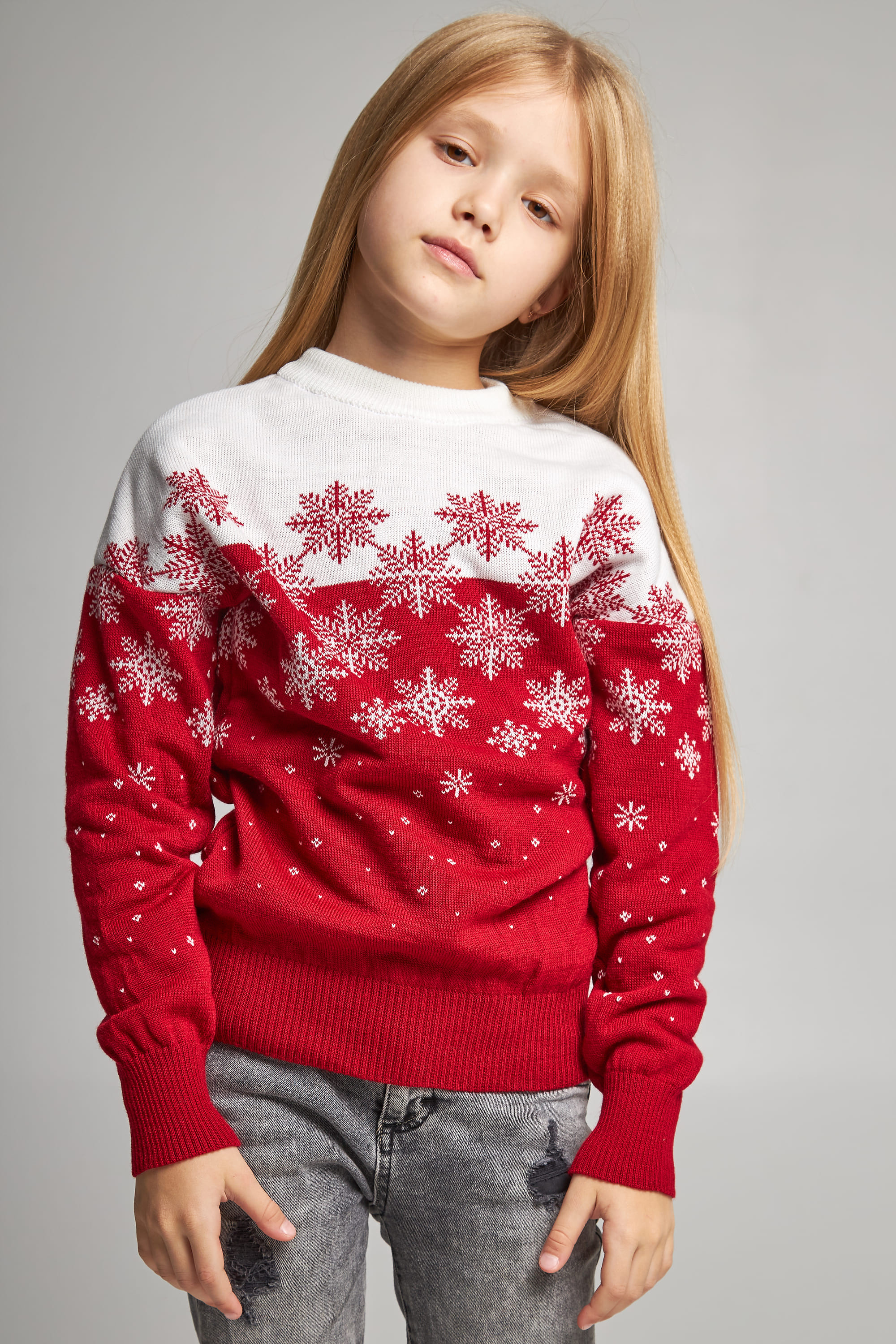 Knitted sweater for a girl snowflakes red