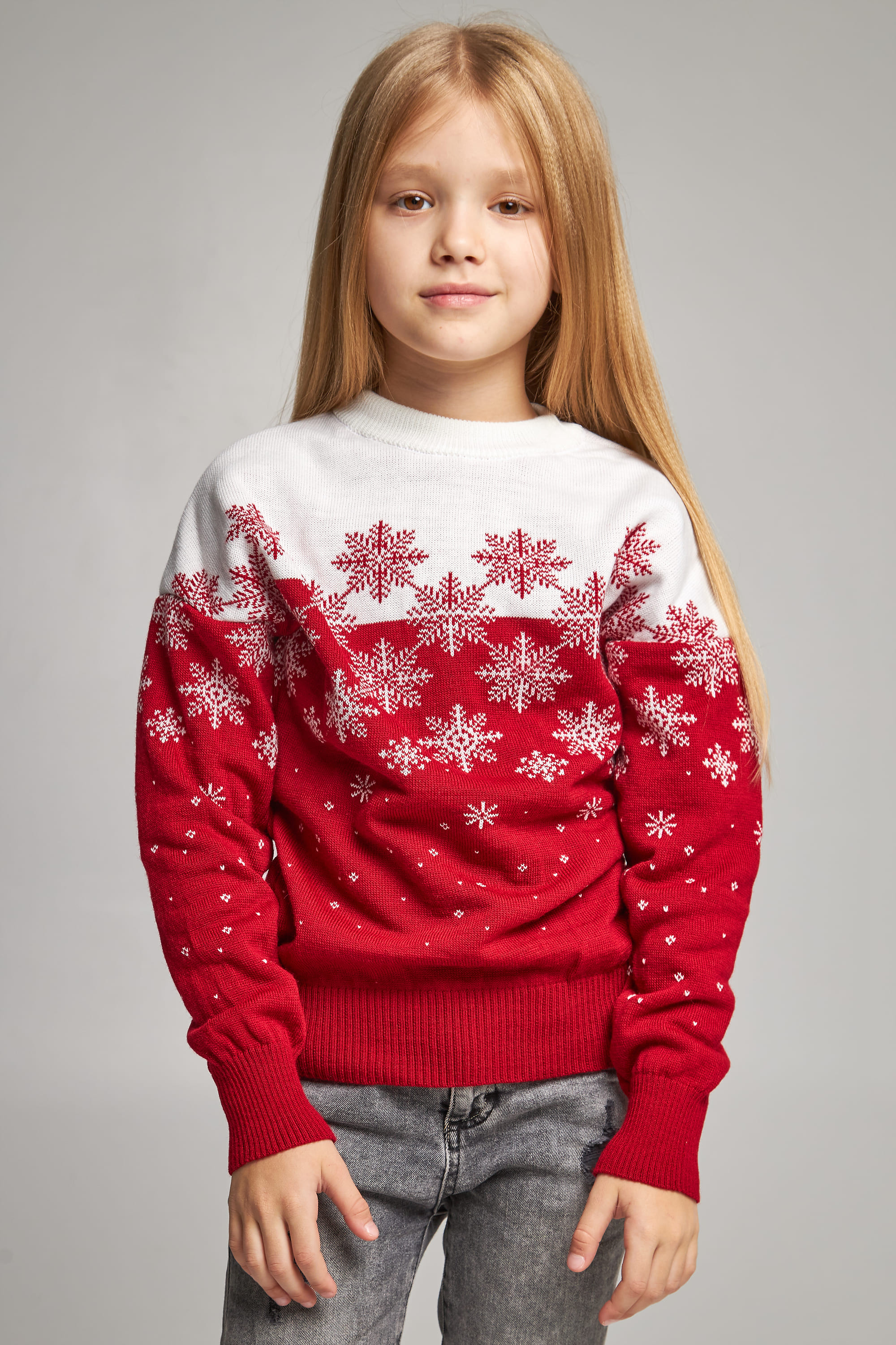 Knitted sweater for a girl snowflakes red