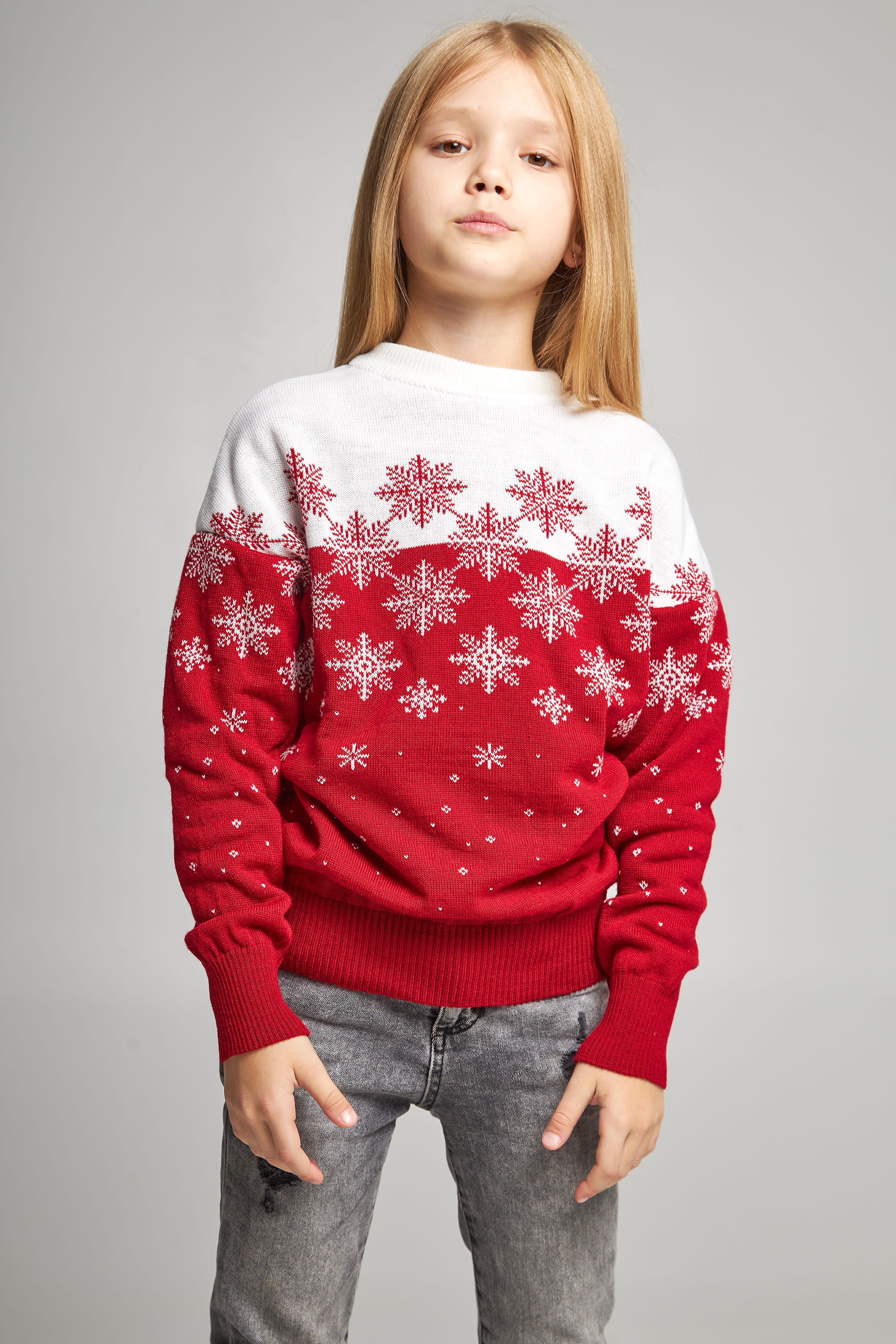 Knitted sweater for a girl snowflakes red