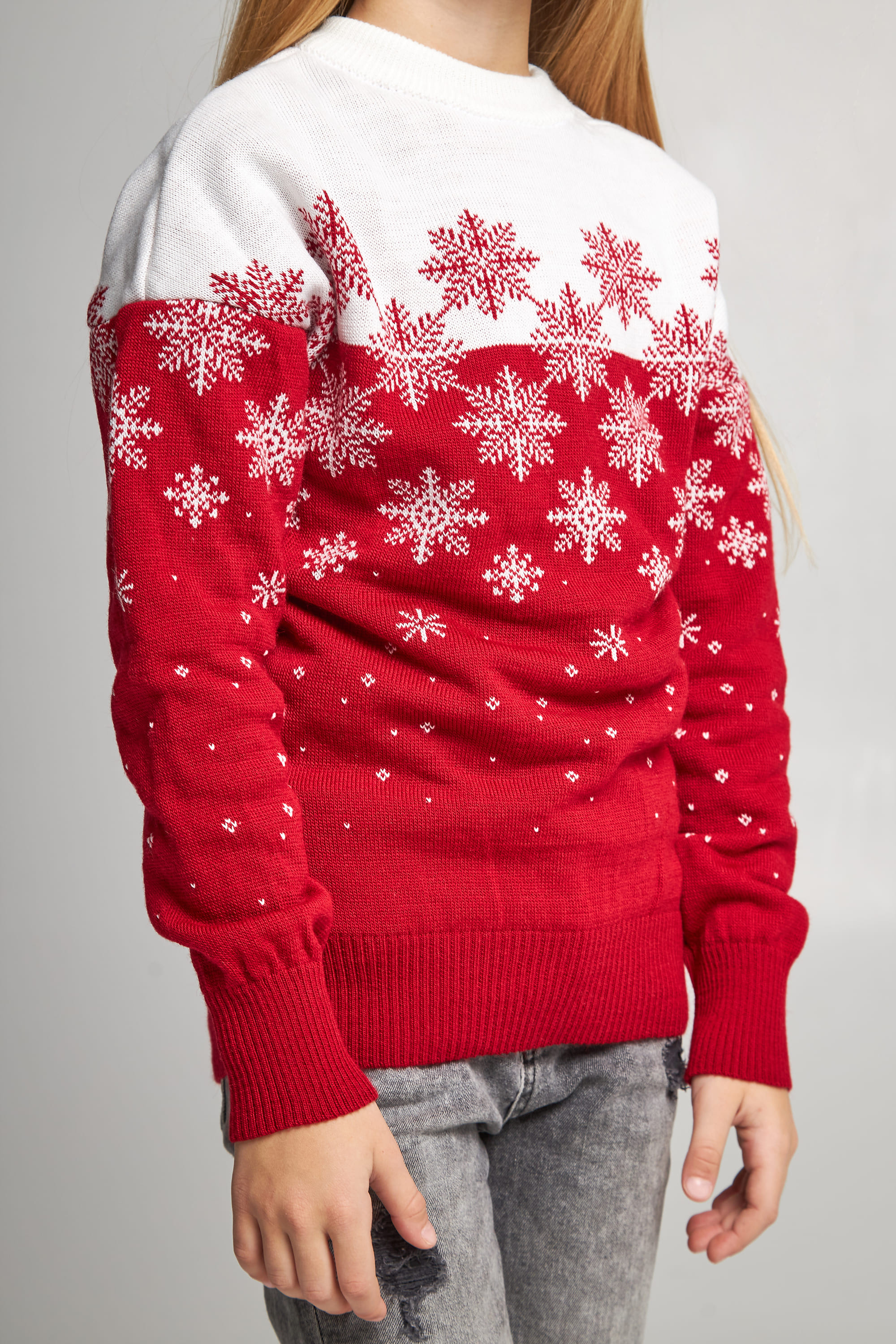 Knitted sweater for a girl snowflakes red