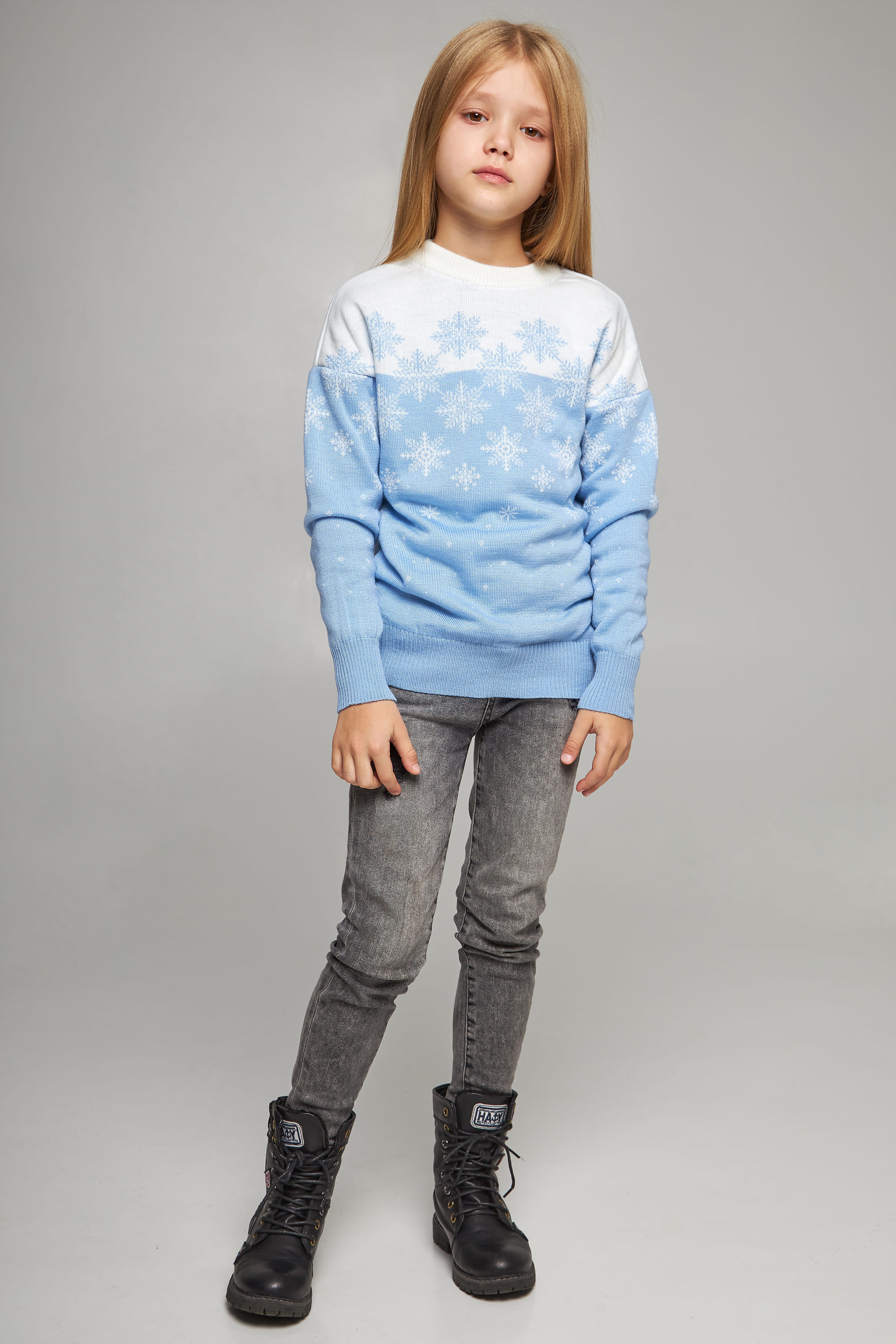 Knitted sweater for a girl Blue snowflakes