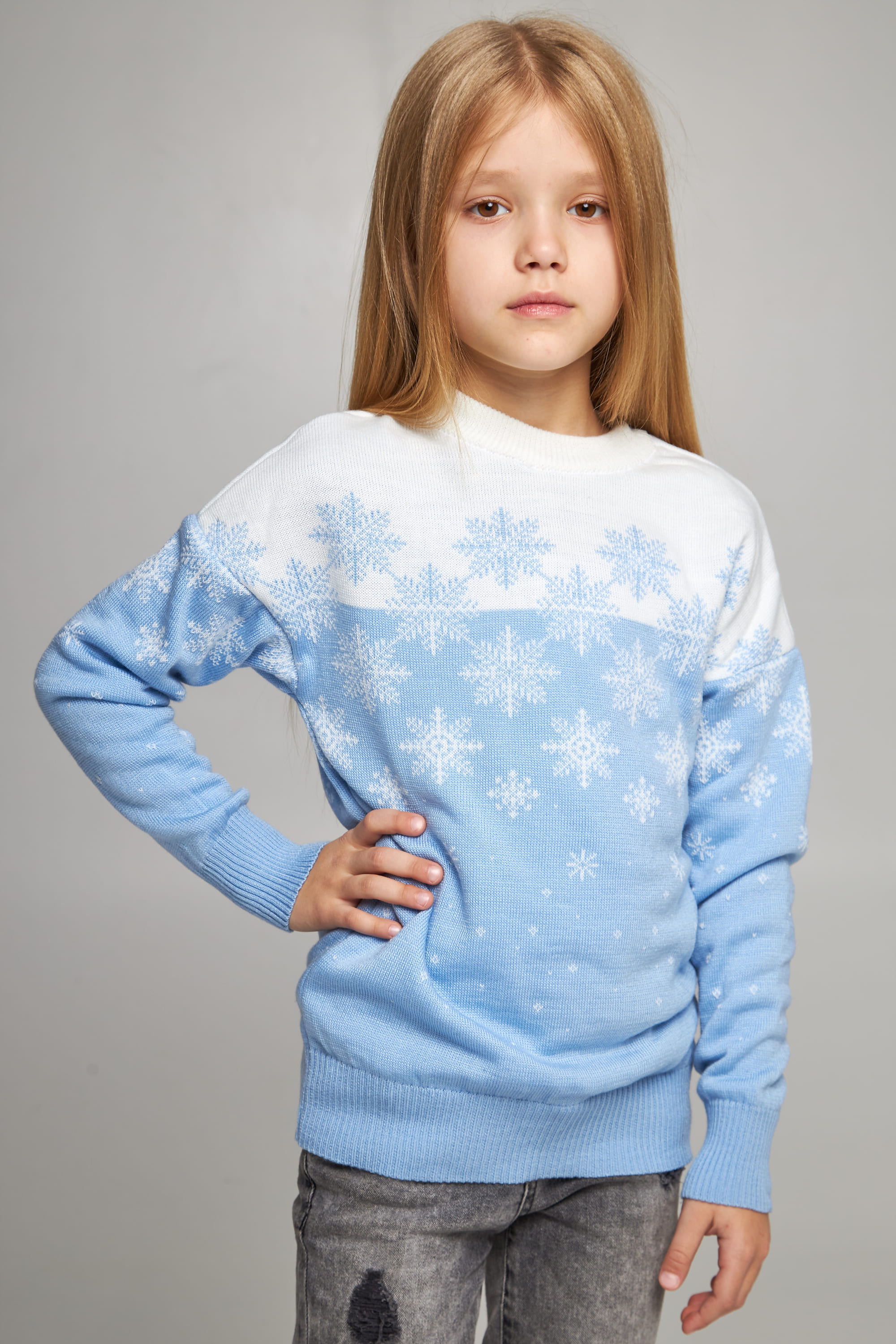 Knitted sweater for a girl Blue snowflakes