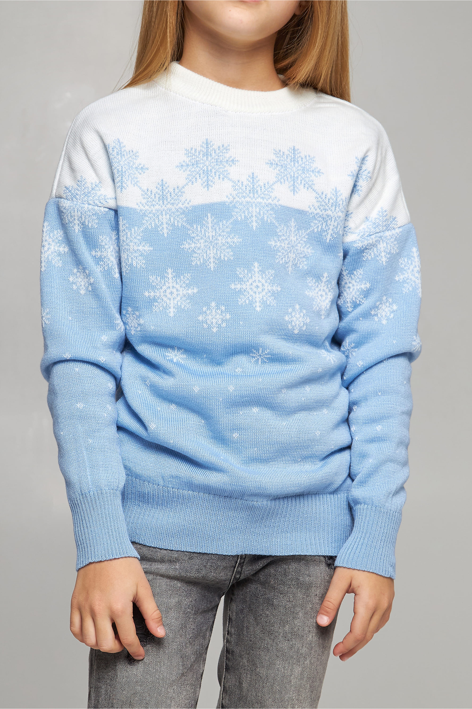 Knitted sweater for a girl Blue snowflakes