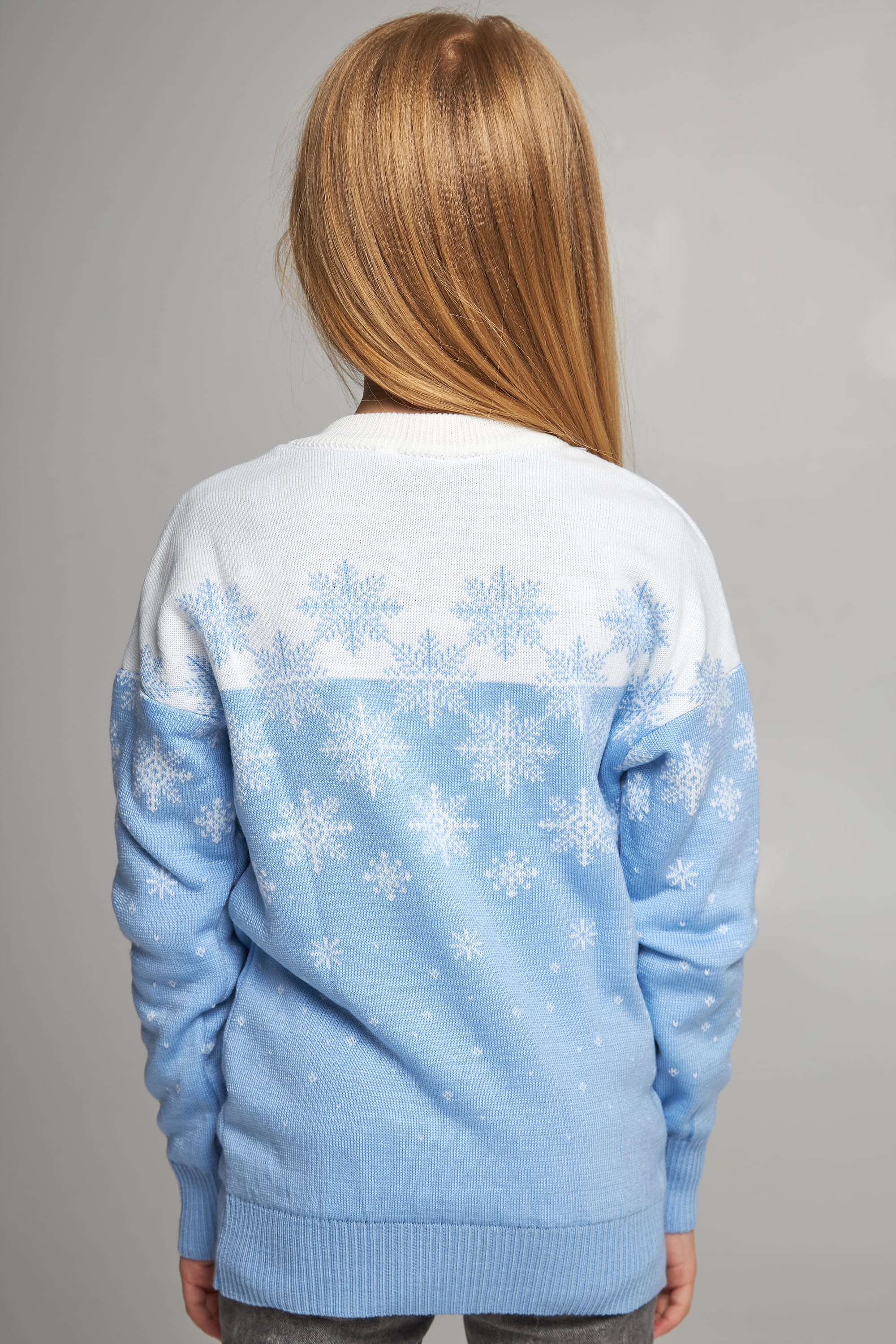Knitted sweater for a girl Blue snowflakes