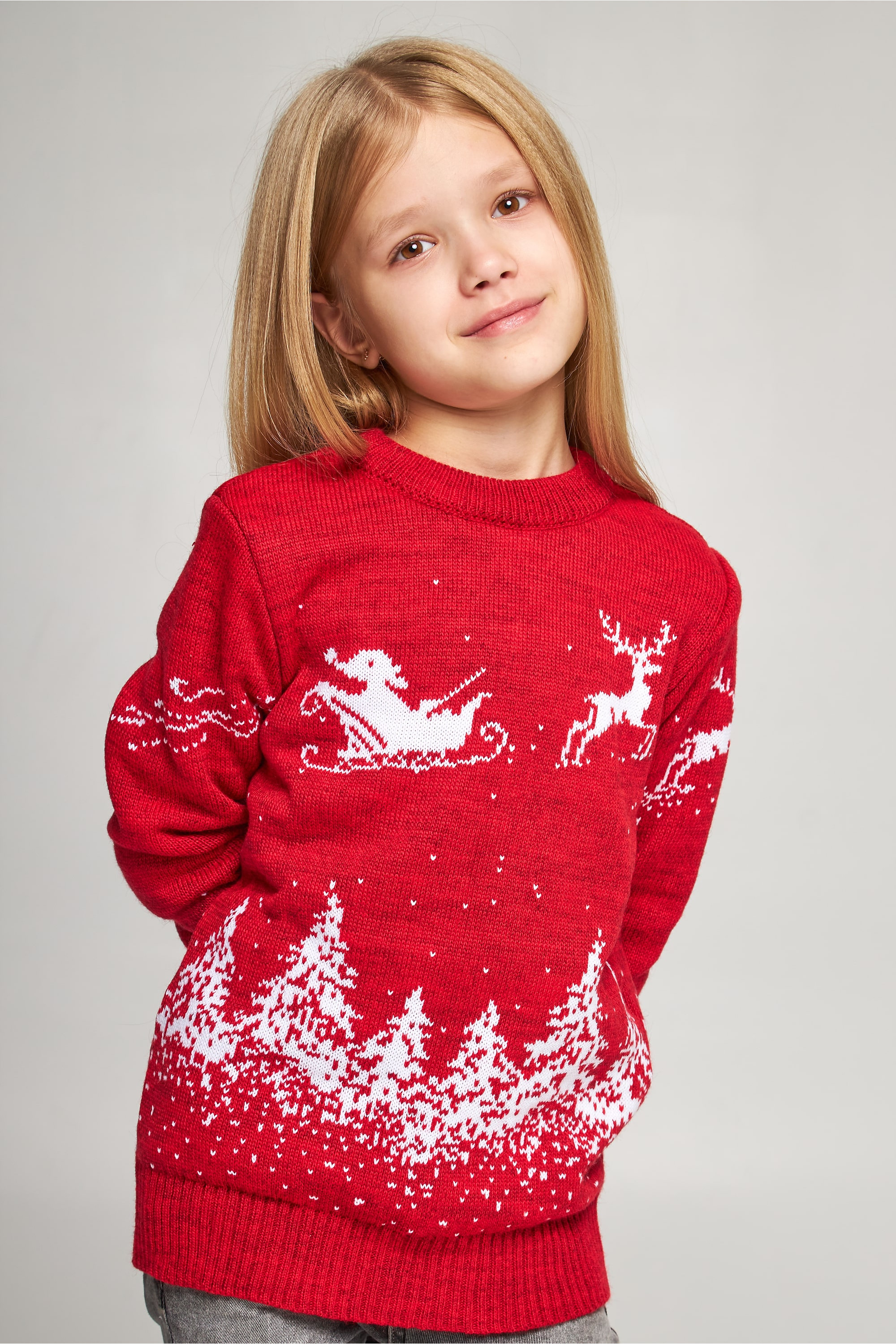 Knitted sweater for a girl Santa Claus with deer red deer