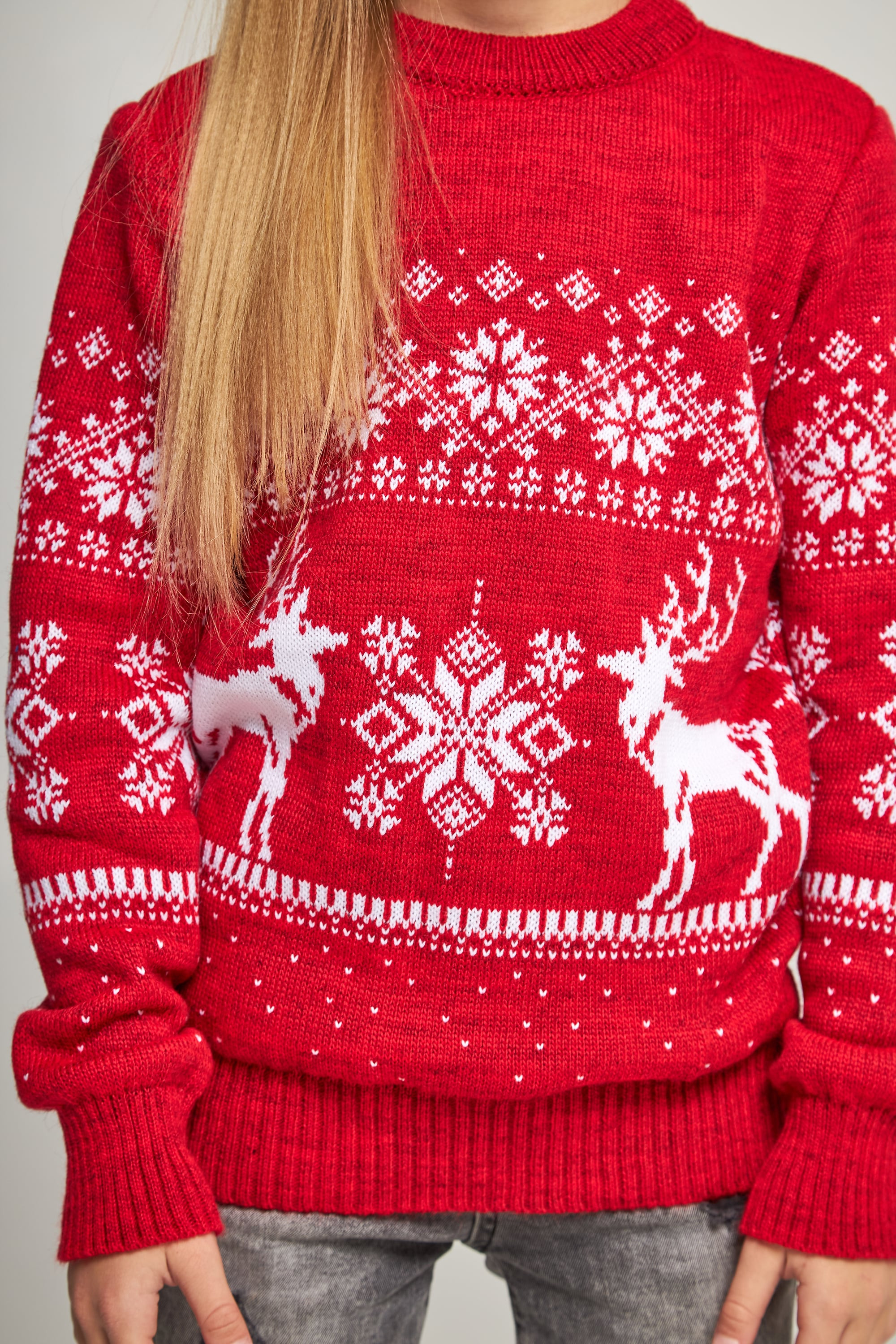 Knitted sweater for a girl snowflakes with deer red deer