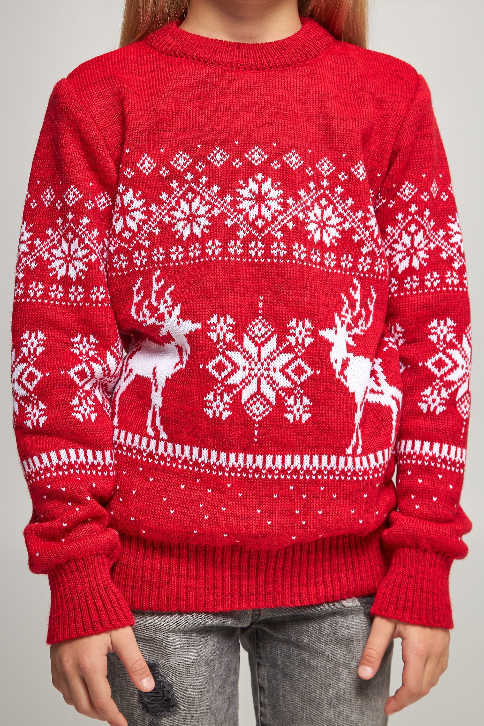 Knitted sweater for a girl snowflakes with deer red deer