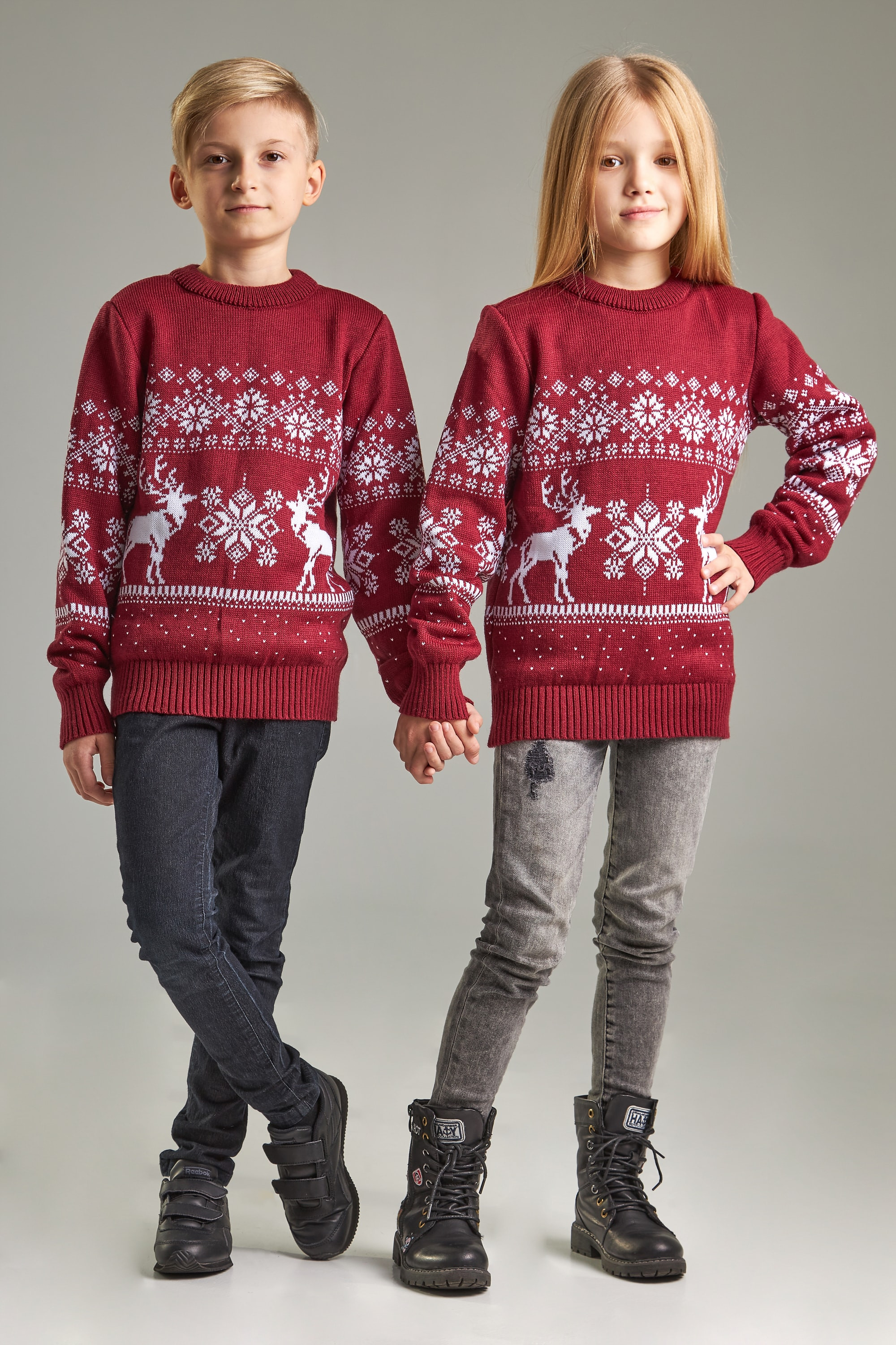New Year's knitted children's sweaters for two Santa Claus with deer burgundy
