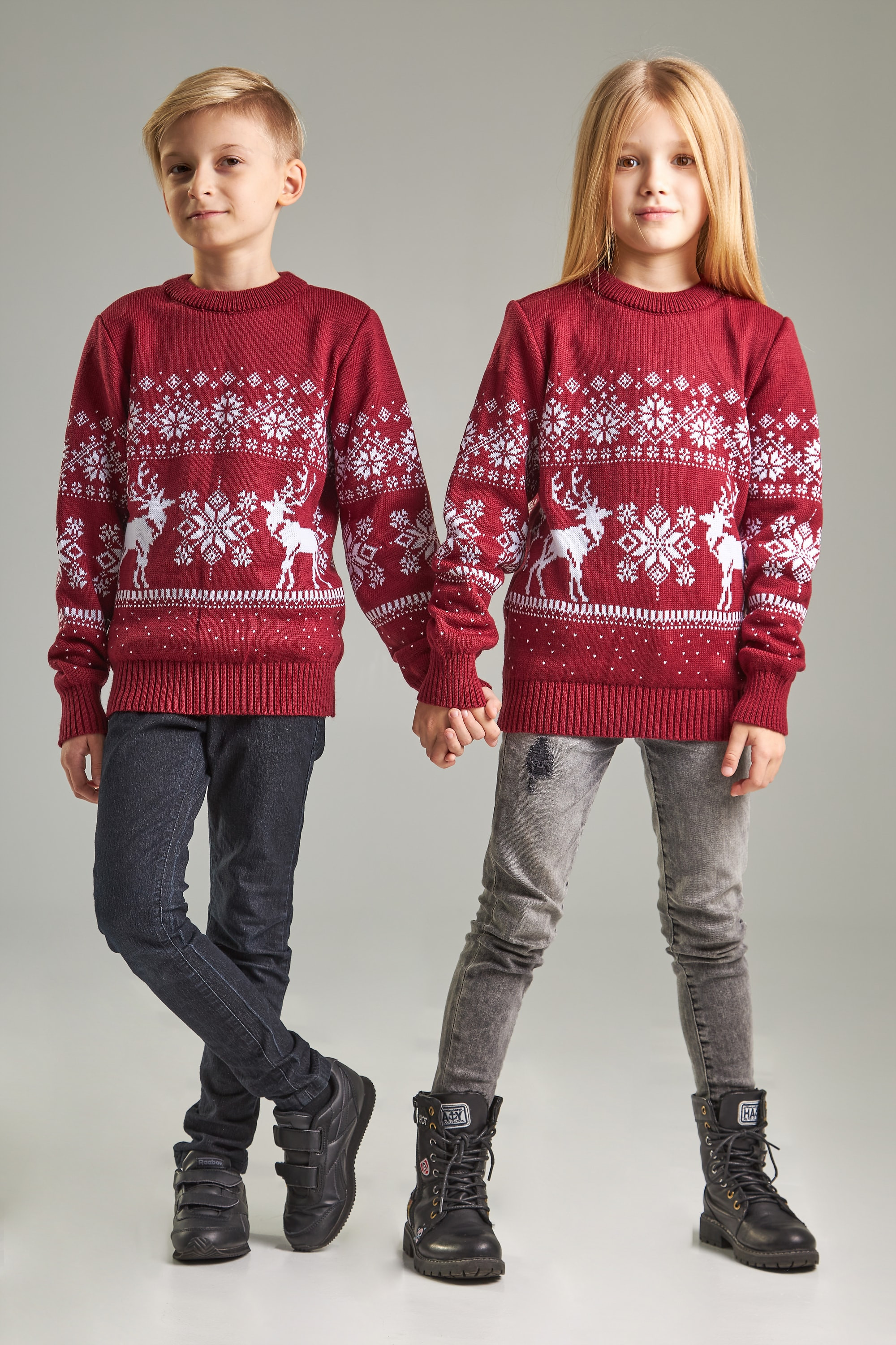 New Year's knitted children's sweaters for two Santa Claus with deer burgundy
