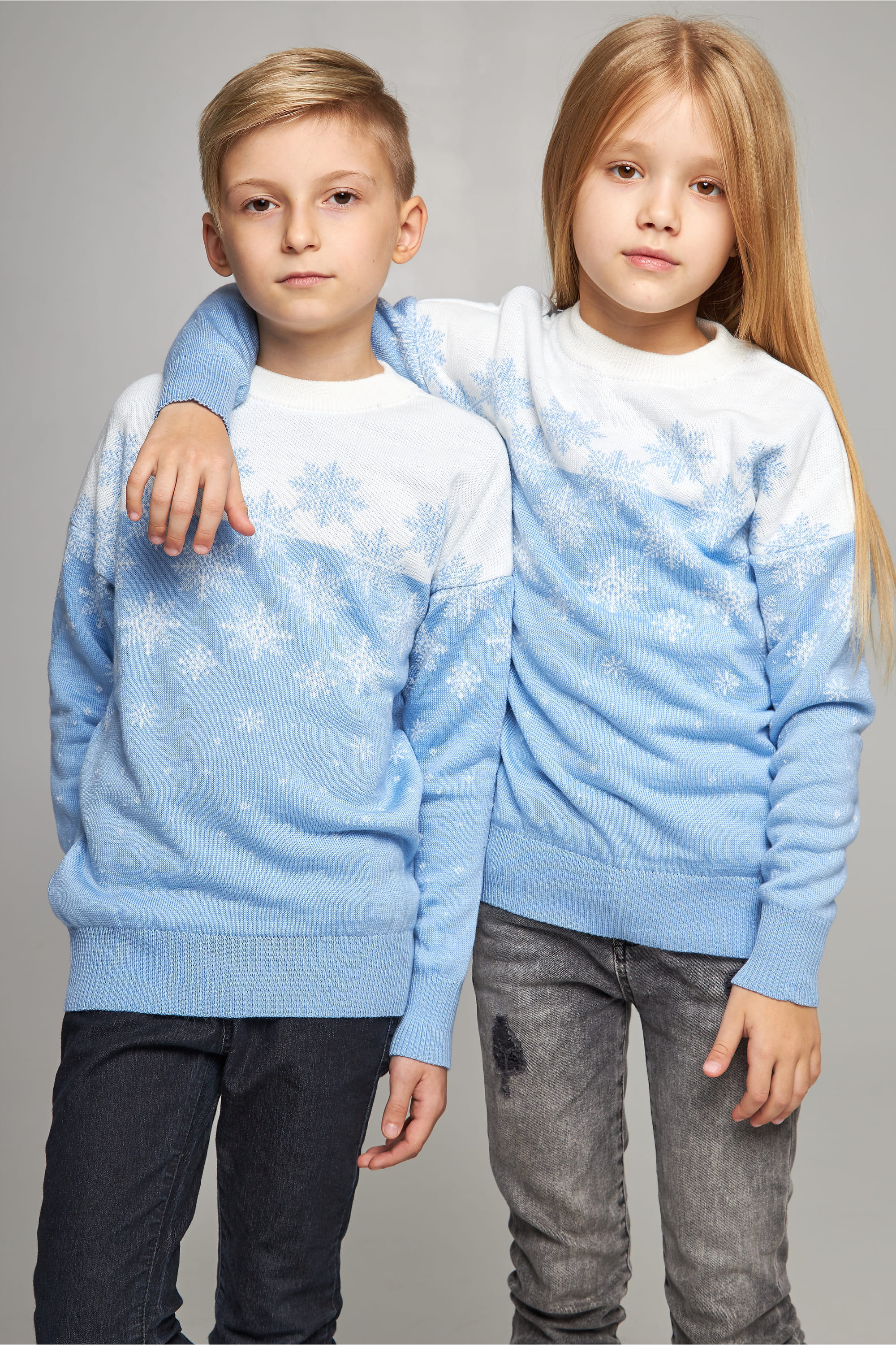 New Year's knitted children's sweaters for two snowflakes blue