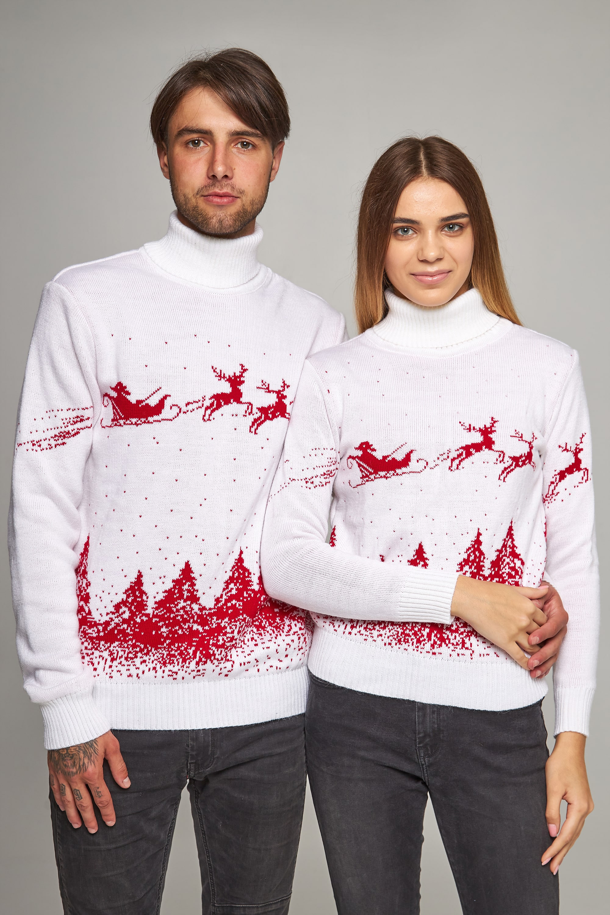 New Year's knitted golfs for two Santa Claus with deer