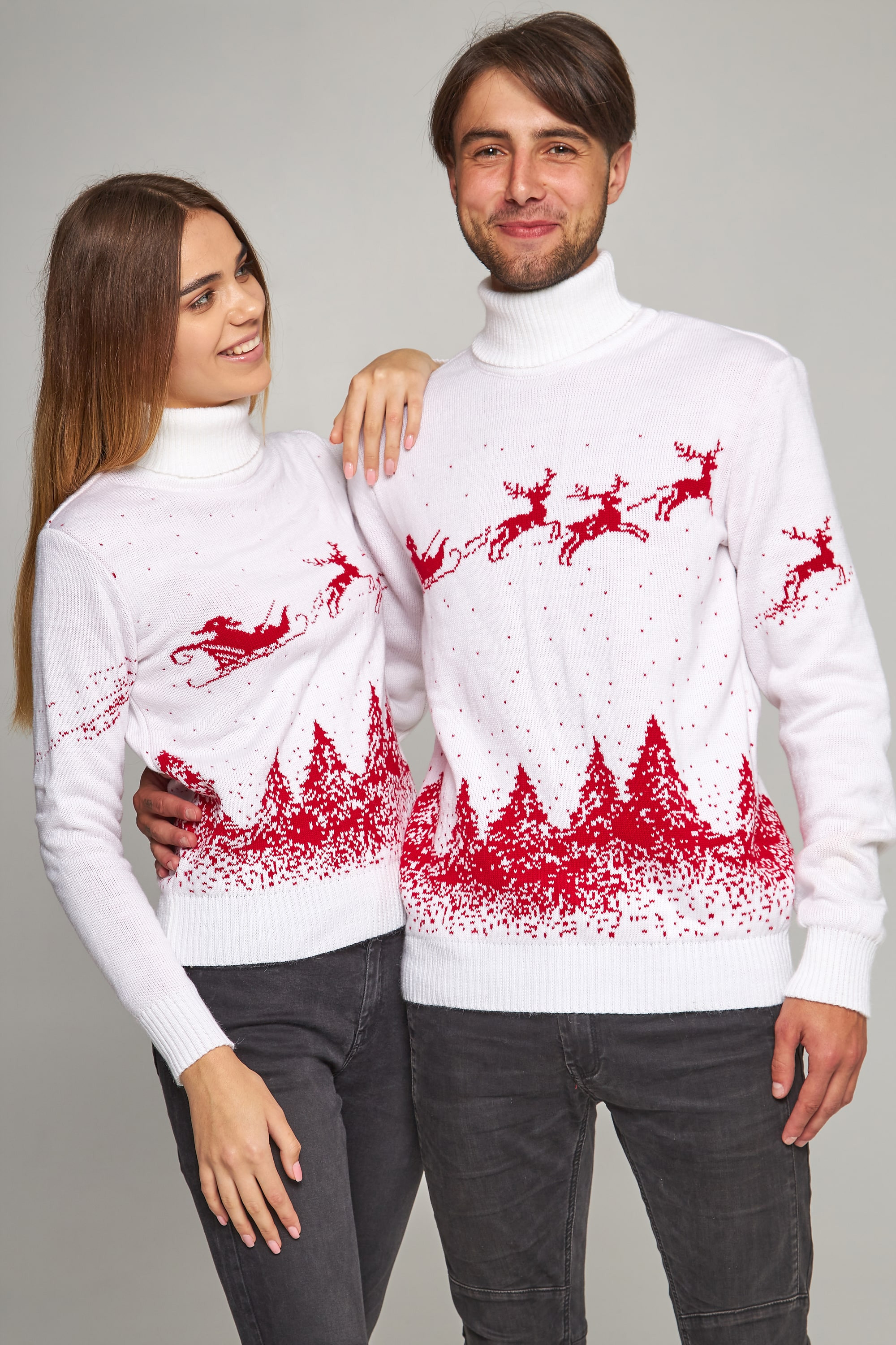 New Year's knitted golfs for two Santa Claus with deer