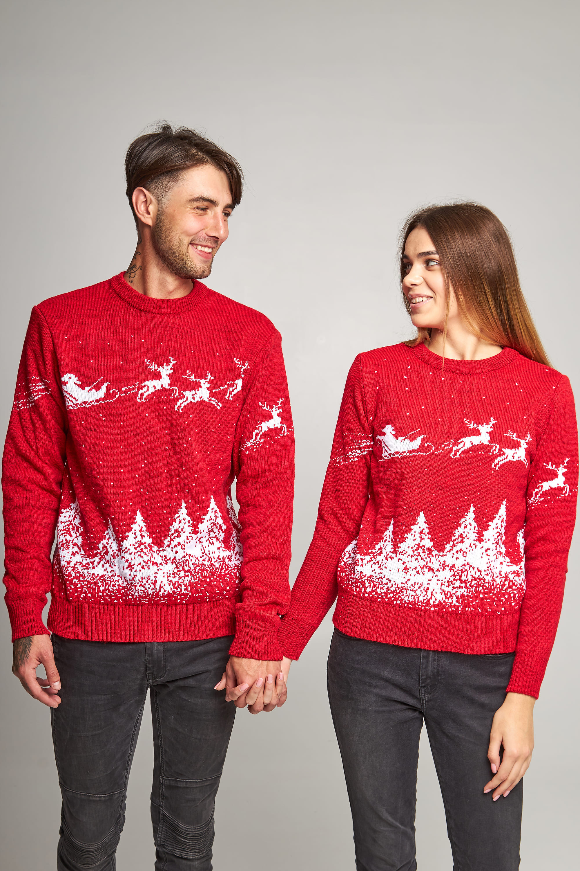 New Year's sweaters for two Santa Claus with deer red