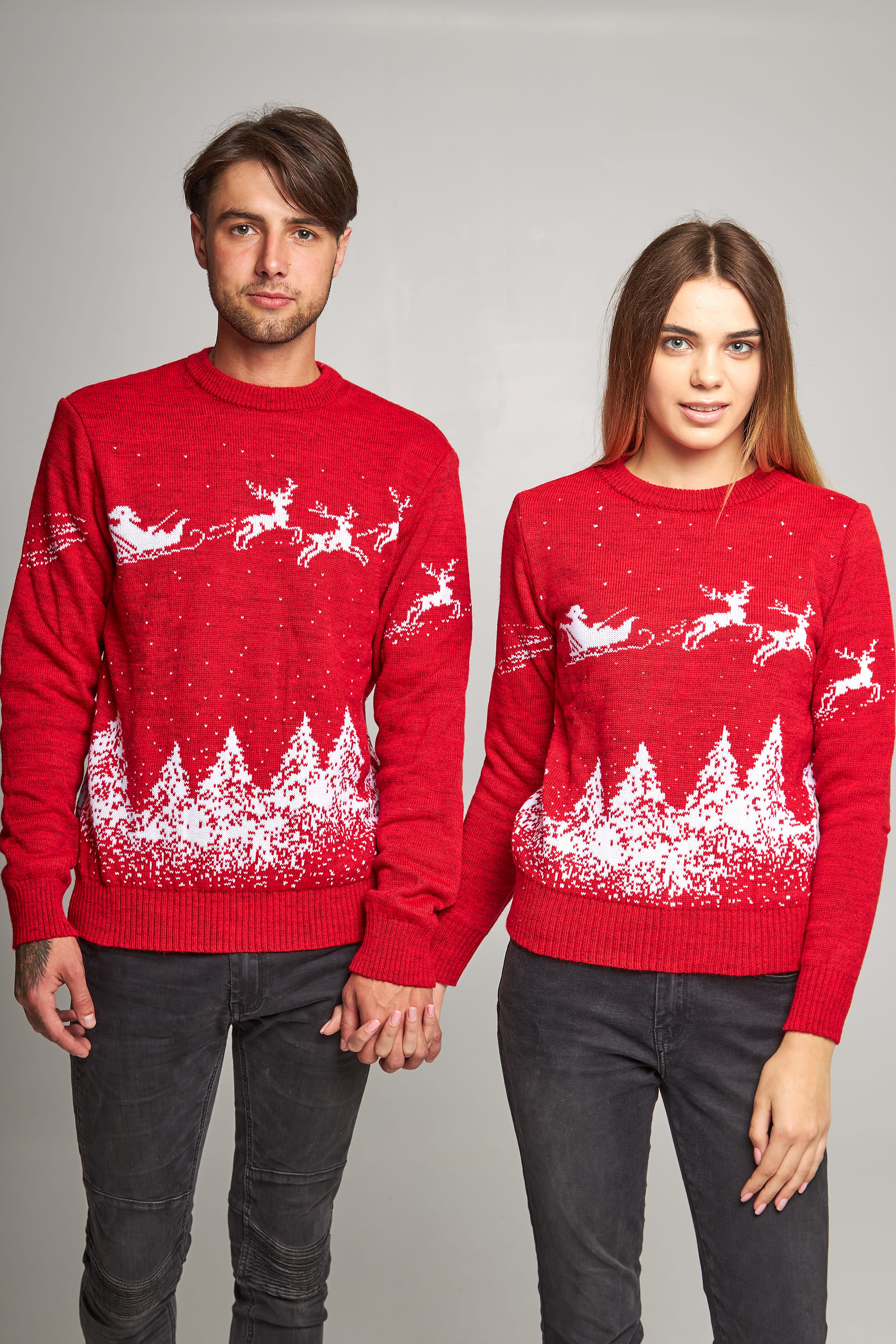 New Year's sweaters for two Santa Claus with deer red