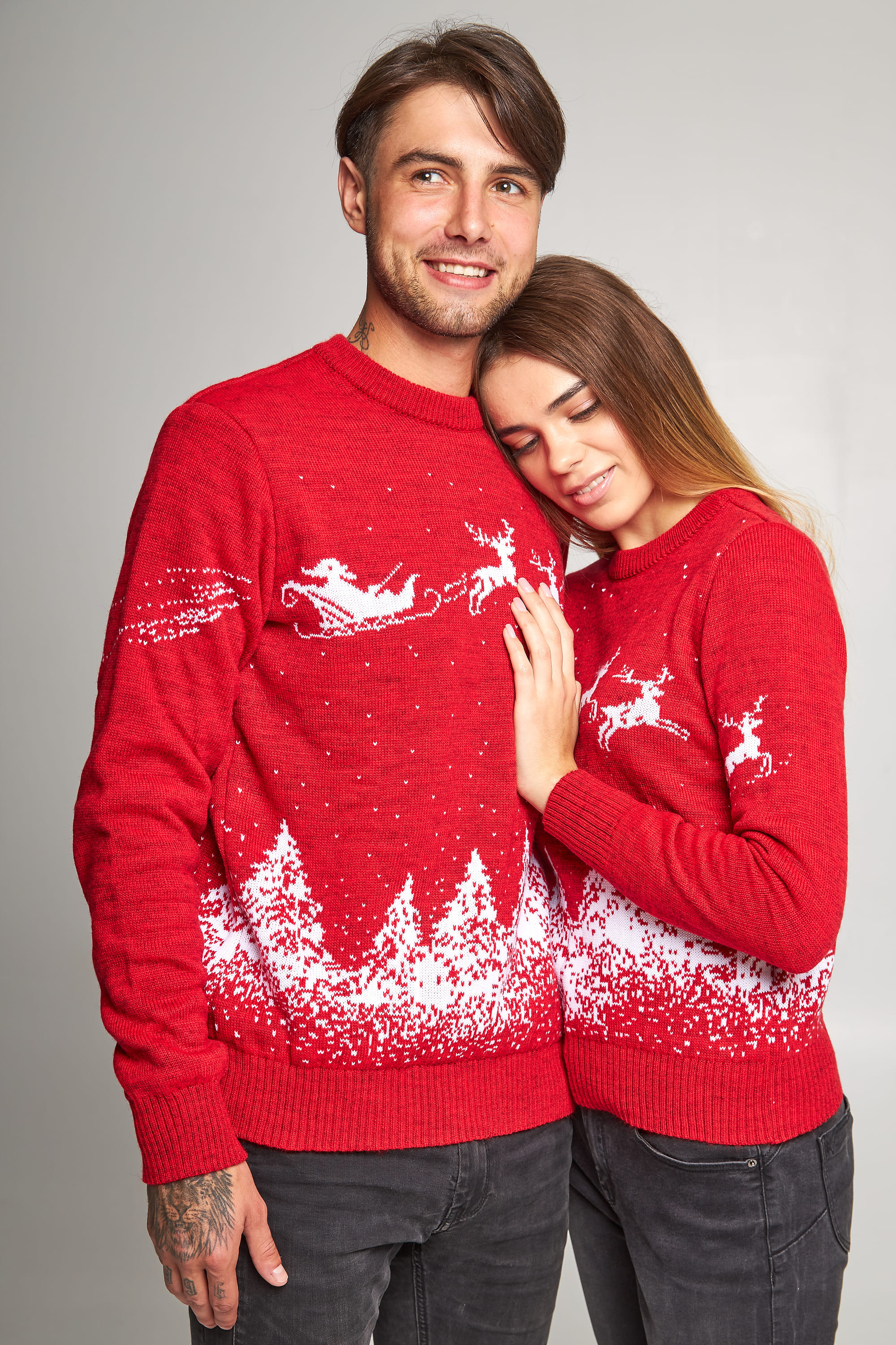 New Year's sweaters for two Santa Claus with deer red