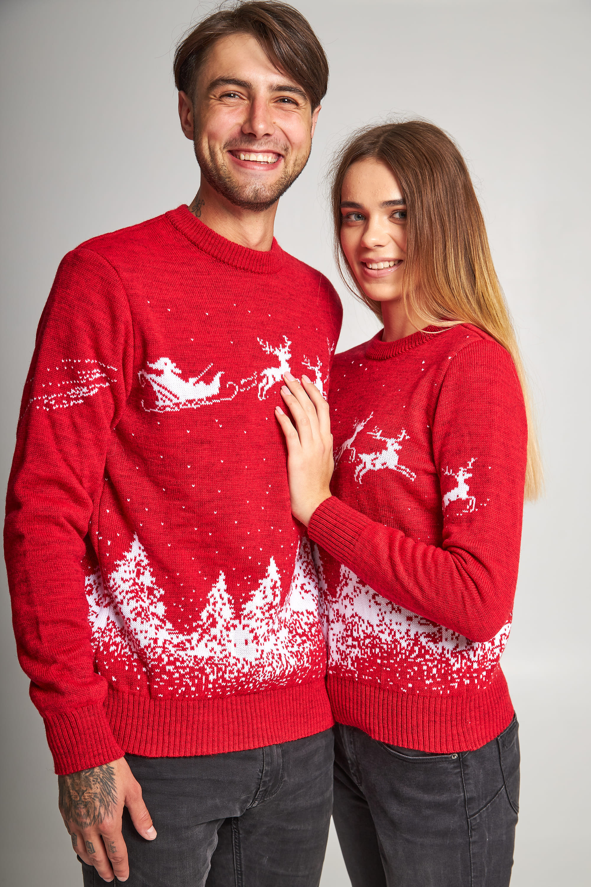 New Year's sweaters for two Santa Claus with deer red