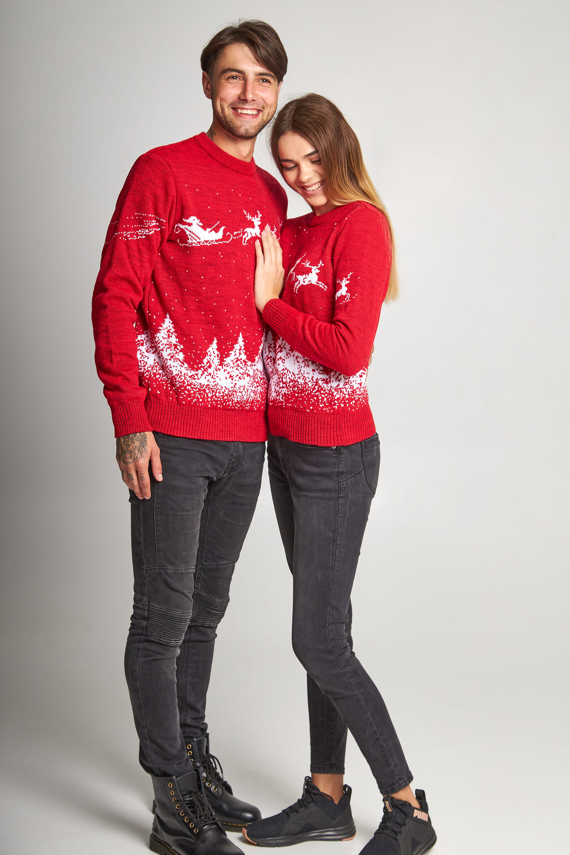 New Year's sweaters for two Santa Claus with deer red