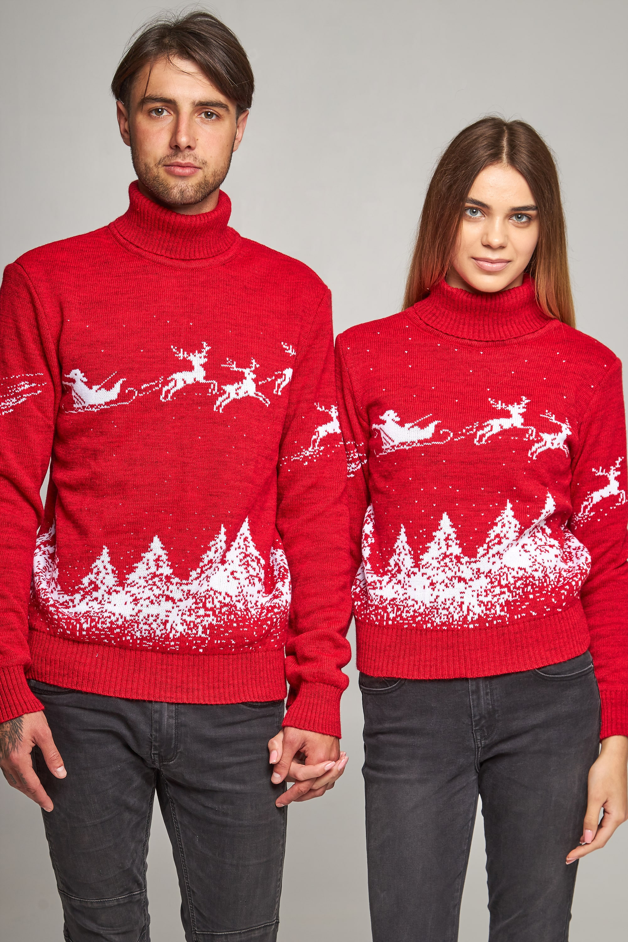 New Year's knitted golfs for two Santa Claus with deer red deer