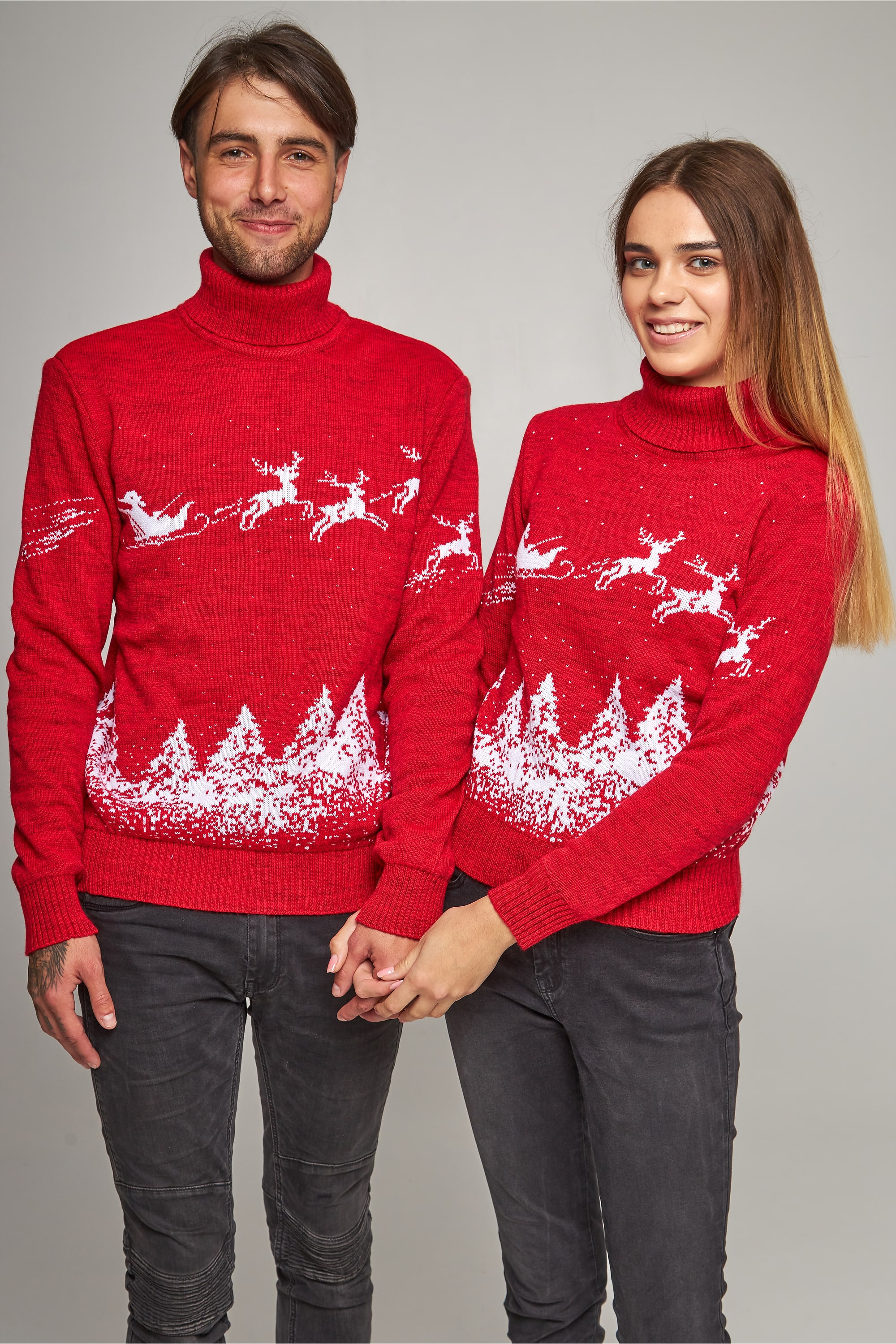 New Year's knitted golfs for two Santa Claus with deer red deer