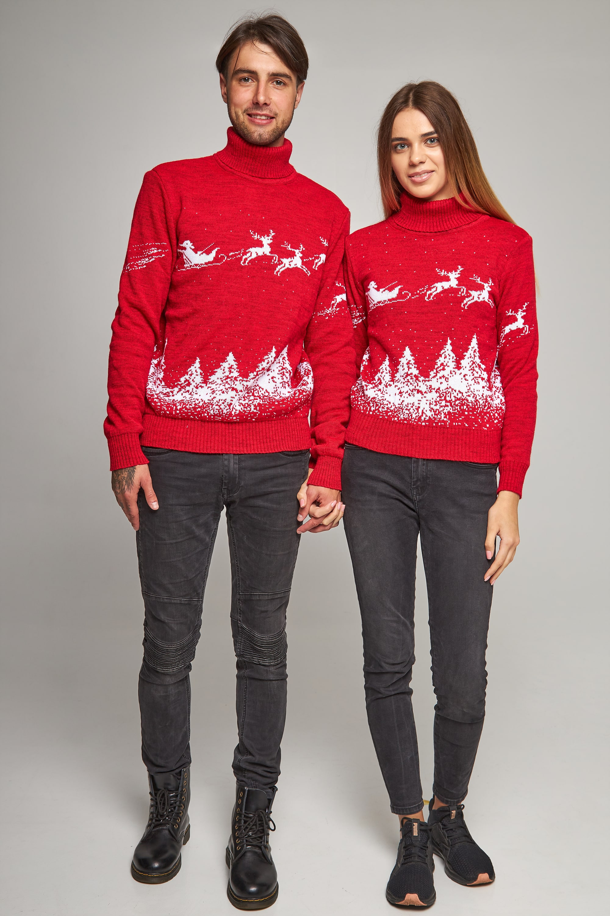 New Year's knitted golfs for two Santa Claus with deer red deer