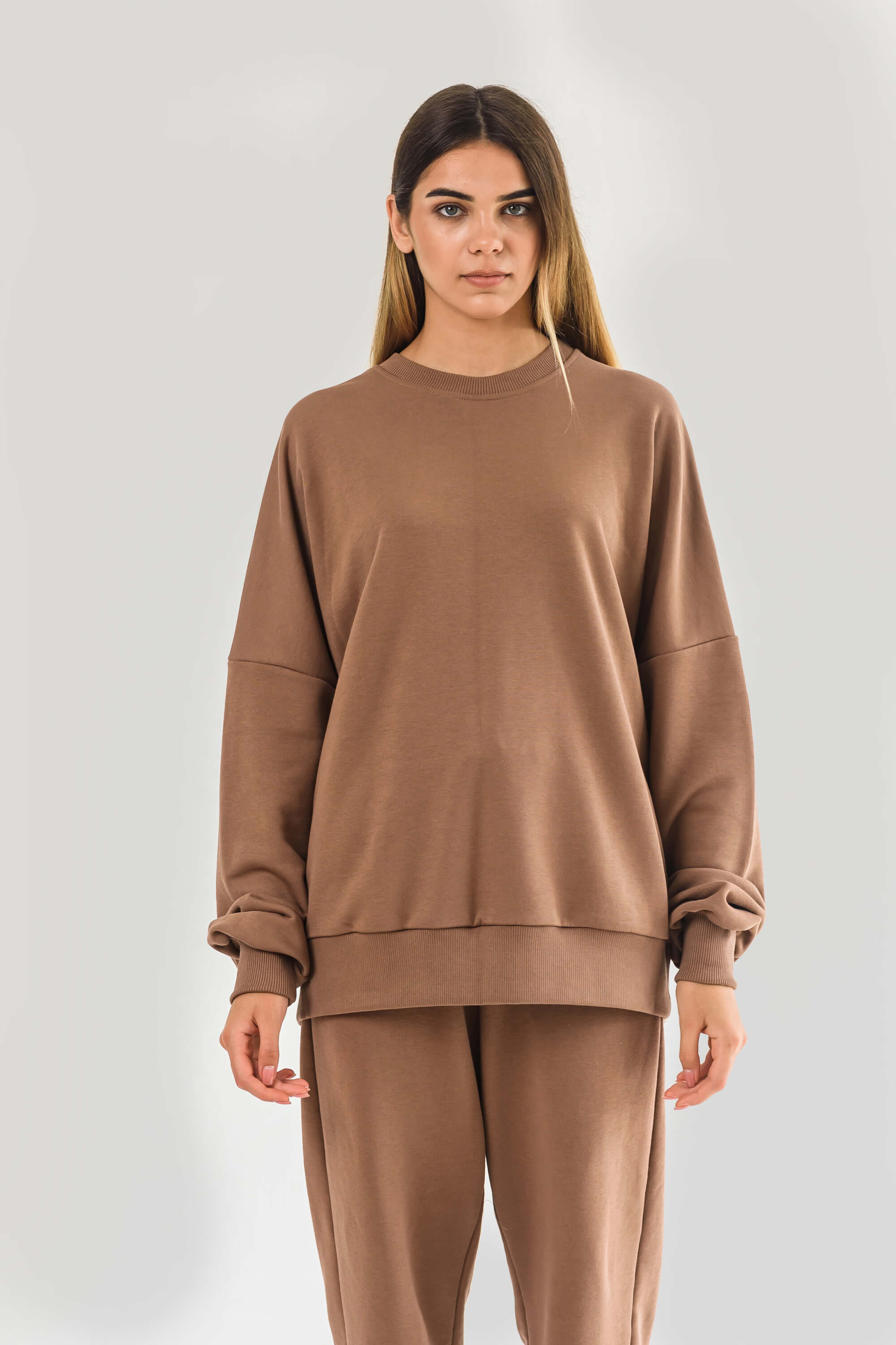 The sweatshirt is beige